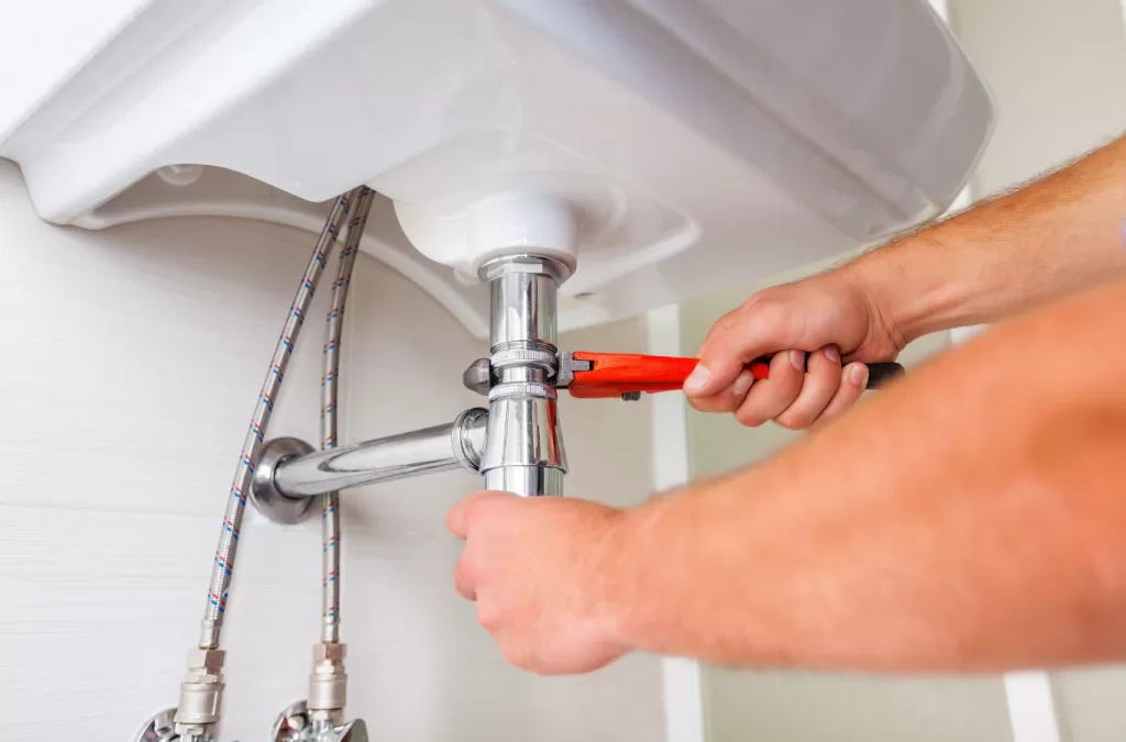 Benefits of plumbing and HVAC services in Gunbarrel, CO by MESA PLUMBING, showing a plumber working on a residential water heater.