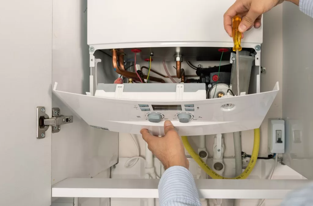 Image of a Mesa Plumbing technician inspecting and repairing a residential boiler system.